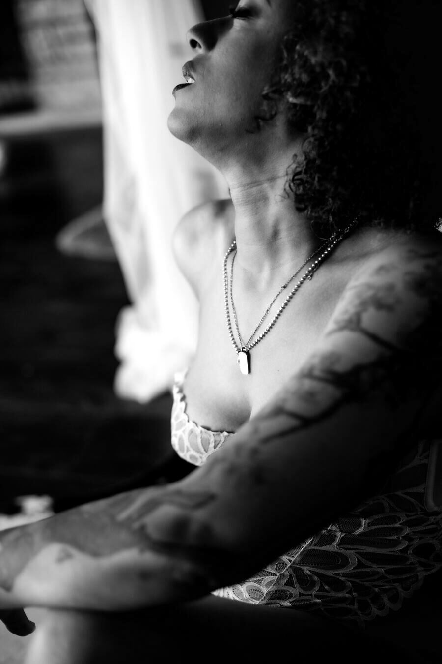 Black and white detail shot from a discreet Las Vegas boudoir session, focused on jewelry and skin rather than full exposure