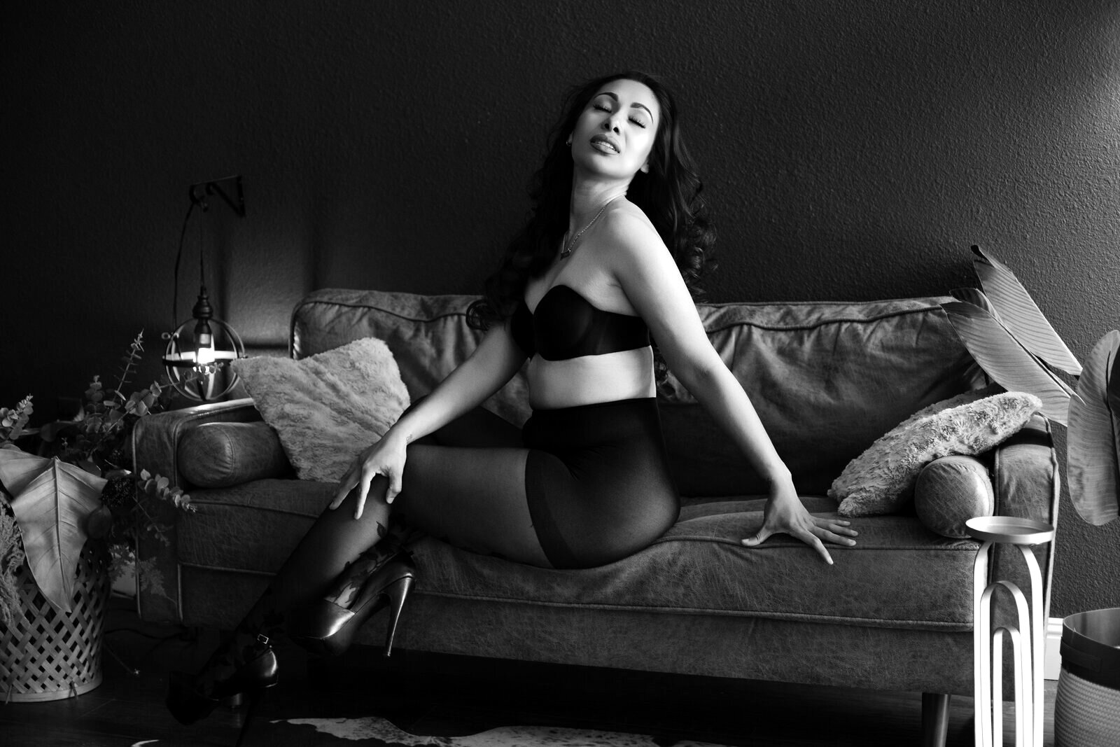Black and white boudoir portrait of a Las Vegas woman exhaling and fully at ease during her photography session